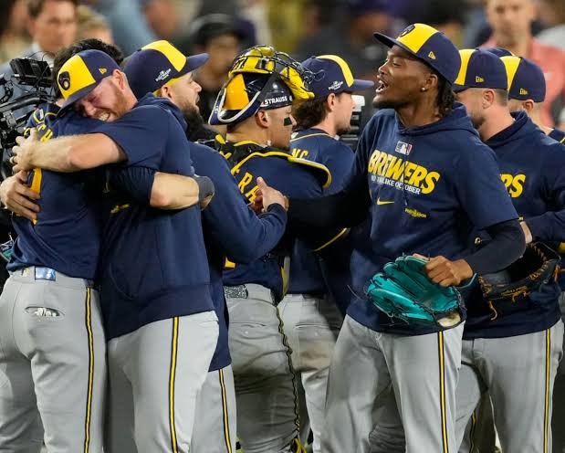 Milwaukee Brewers players embracing and celebrating together after a win